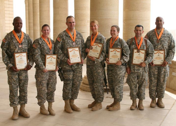 MND-B scholar, comrades keep 'Mercury' rising DVIDS106807.jpg en Seven Soldiers of Company C Division Special Troops Battalion 4th Infantry Division Multi-National Division � Baghdad pose with their plaques and medals after receiving the ...